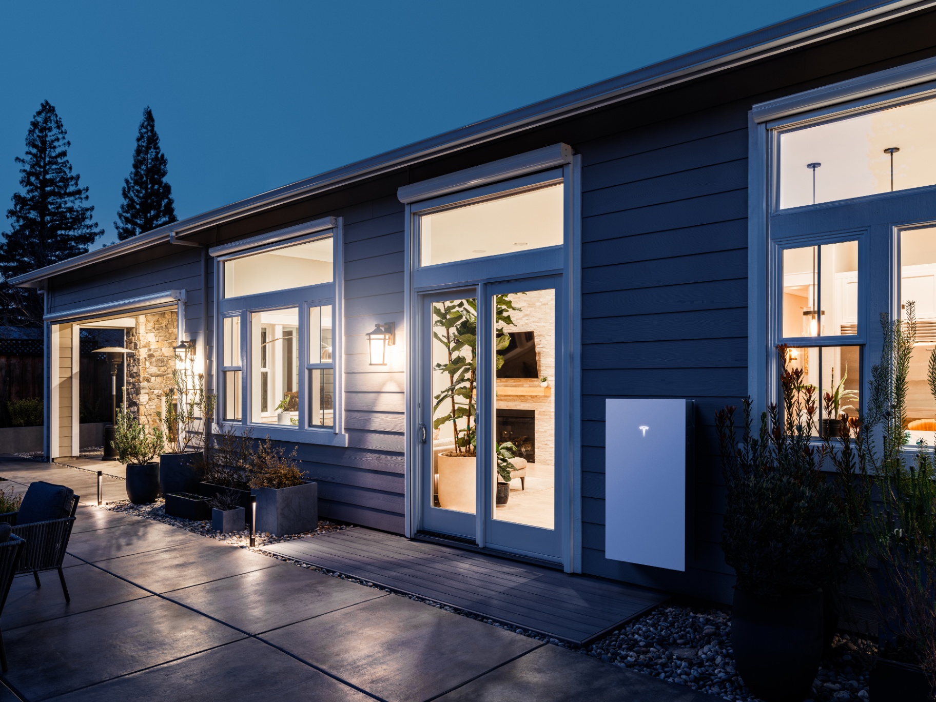Powerwall 3 mounted on a home exterior at night