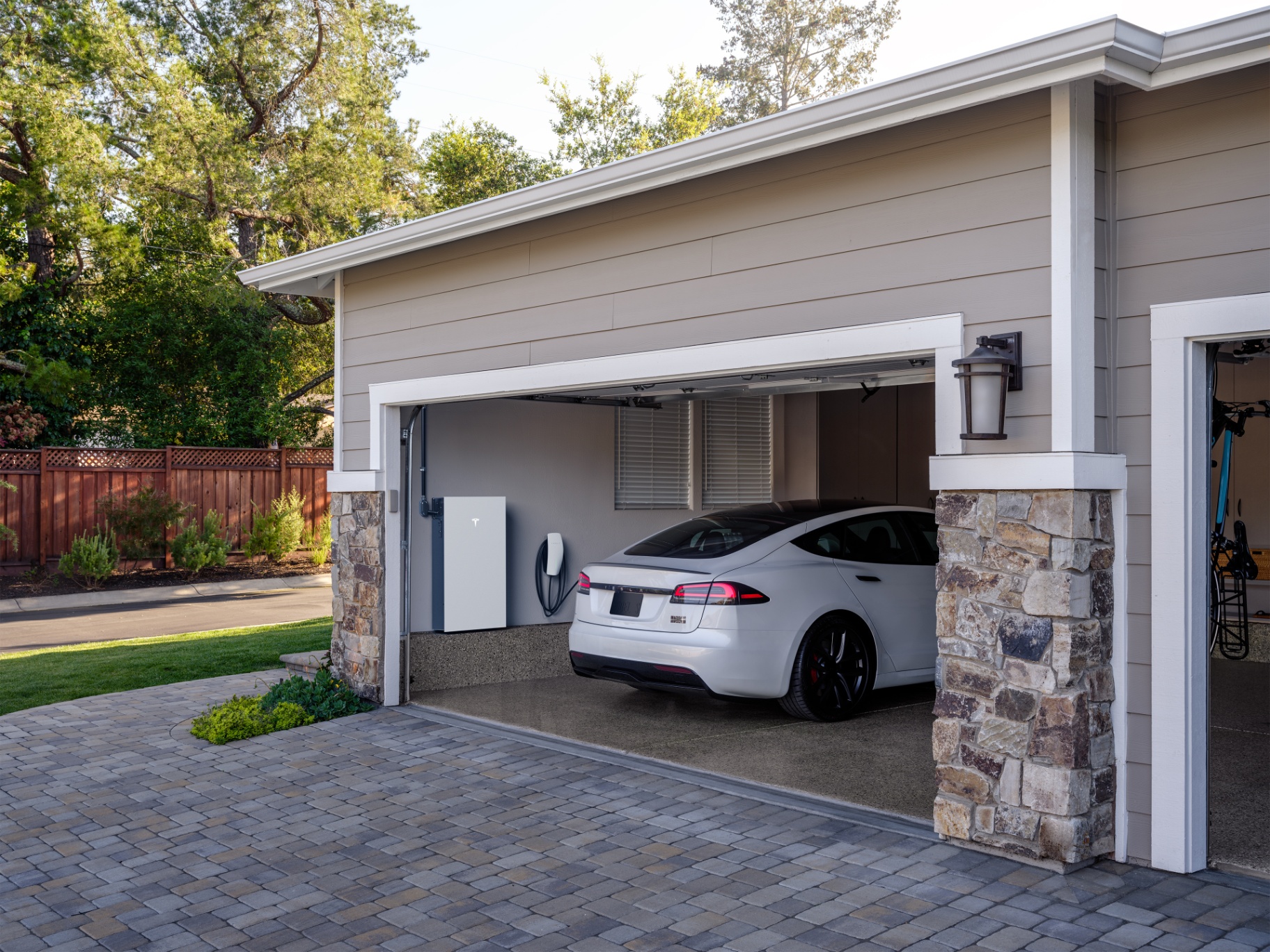 Powerwall 3 installed in a garage with a Tesla
